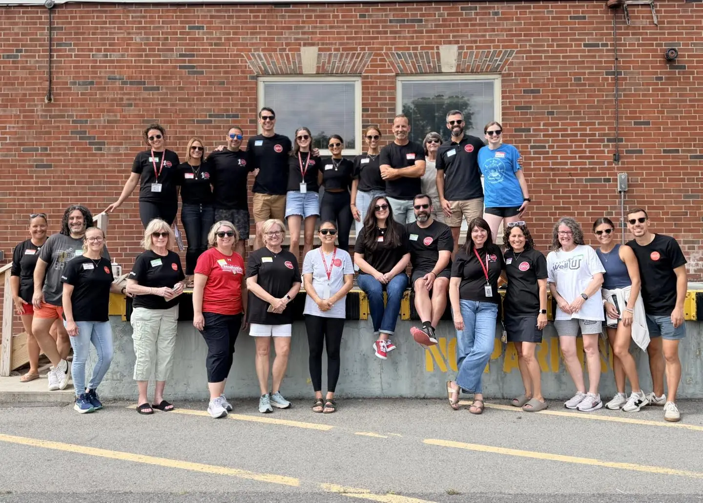 Back to School Bash volunteers in matching T-shirts lined up outside a school
