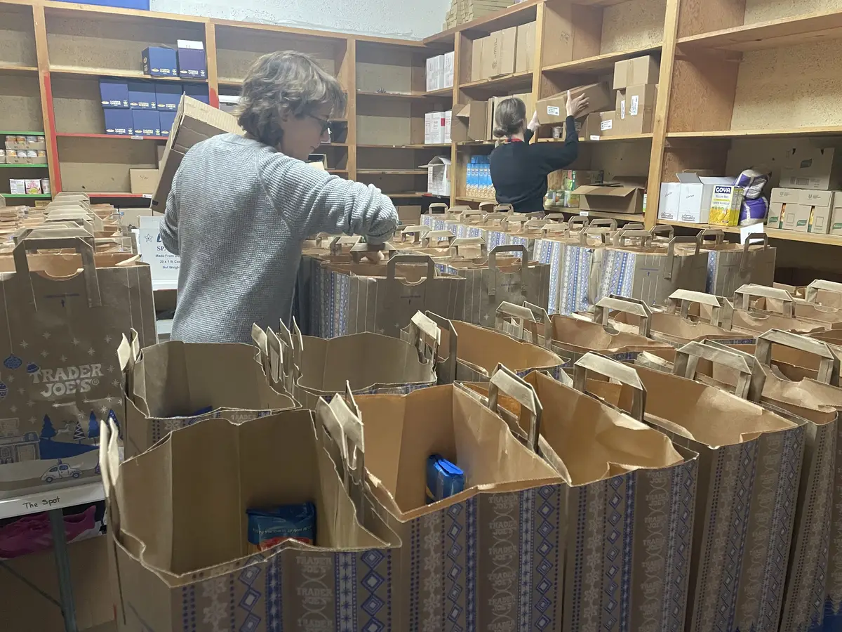 Volunteers packing holiday grocery bags in the SpotMart pantry
